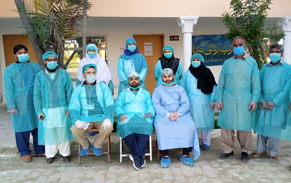 In this undated group photo, Dr. Abrar Hussain Malik, who is a deputy medical superintendent at district headquarters hospital in Chakwal, can be seen in the center along with his other team members. (Photo courtesy: Supplied by Dr. Abrar)