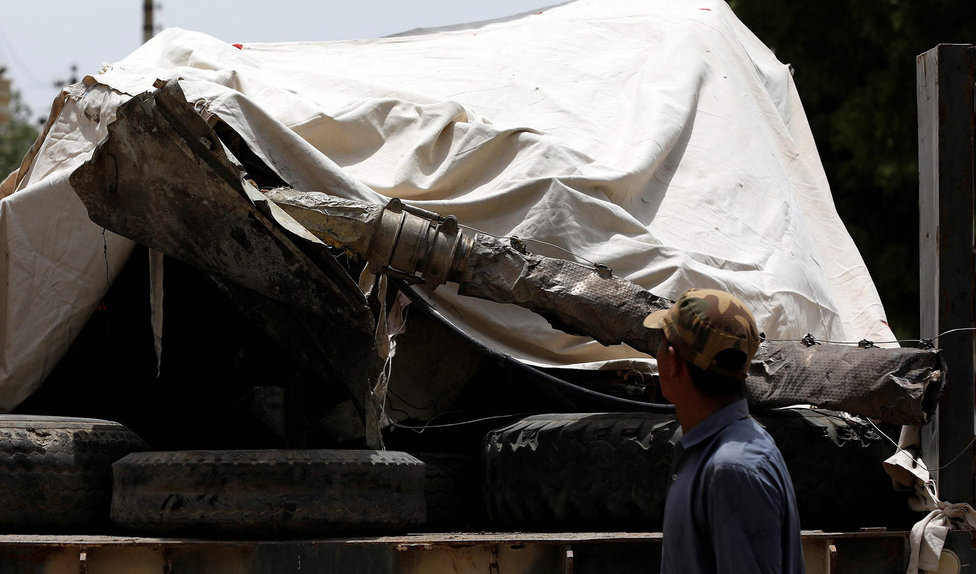 A worker walks past a truck loaded with the wreckage of the crashed Pakistan International Airlines' PK8303 plane, in Karachi on May 28, 2020. (REUTERS)