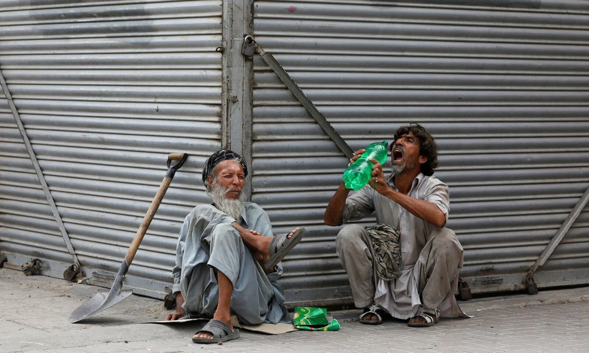 In this file photo, daily wage laborers wait for work as they sit outside closed shops, during lockdown amid the outbreak of coronavirus disease (COVID-19), at a market in Karachi on April 14, 2020. (REUTERS)