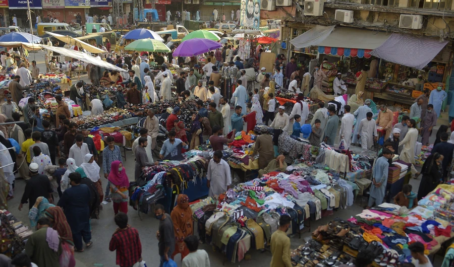 Peoples walk along Raja Bazar ahead of the Muslim Eid al-Fitr festival after the government eased a nationwide lockdown imposed as a preventive measure against the COVID-19 coronavirus in, in Rawalpindi on May 19, 2020. (AFP)