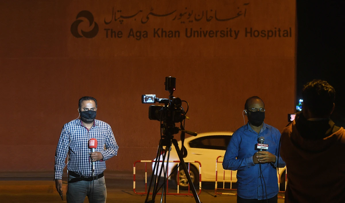 In this file photo, Pakistani journalists wearing protective facemasks report outside the Aga Khan University Hospital where a patient of the COVID-19 novel coronavirus has been admitted in Karachi on Feb. 26, 2020. (AFP)