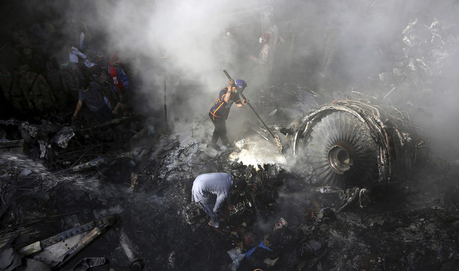 Volunteers look for survivors of a plane that crashed in residential area of Karachi on May 22, 2020. (AP)