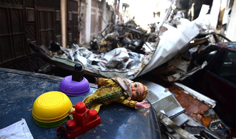 Pieces of fuselage and doll found at the crash site of a Pakistani airliner that plunged into a residential area of Karachi on May 22, 2020. Many passengers aboard were families with children returning home for Eid Al-Fitr holiday. (AN Photo/S.A. Babar)