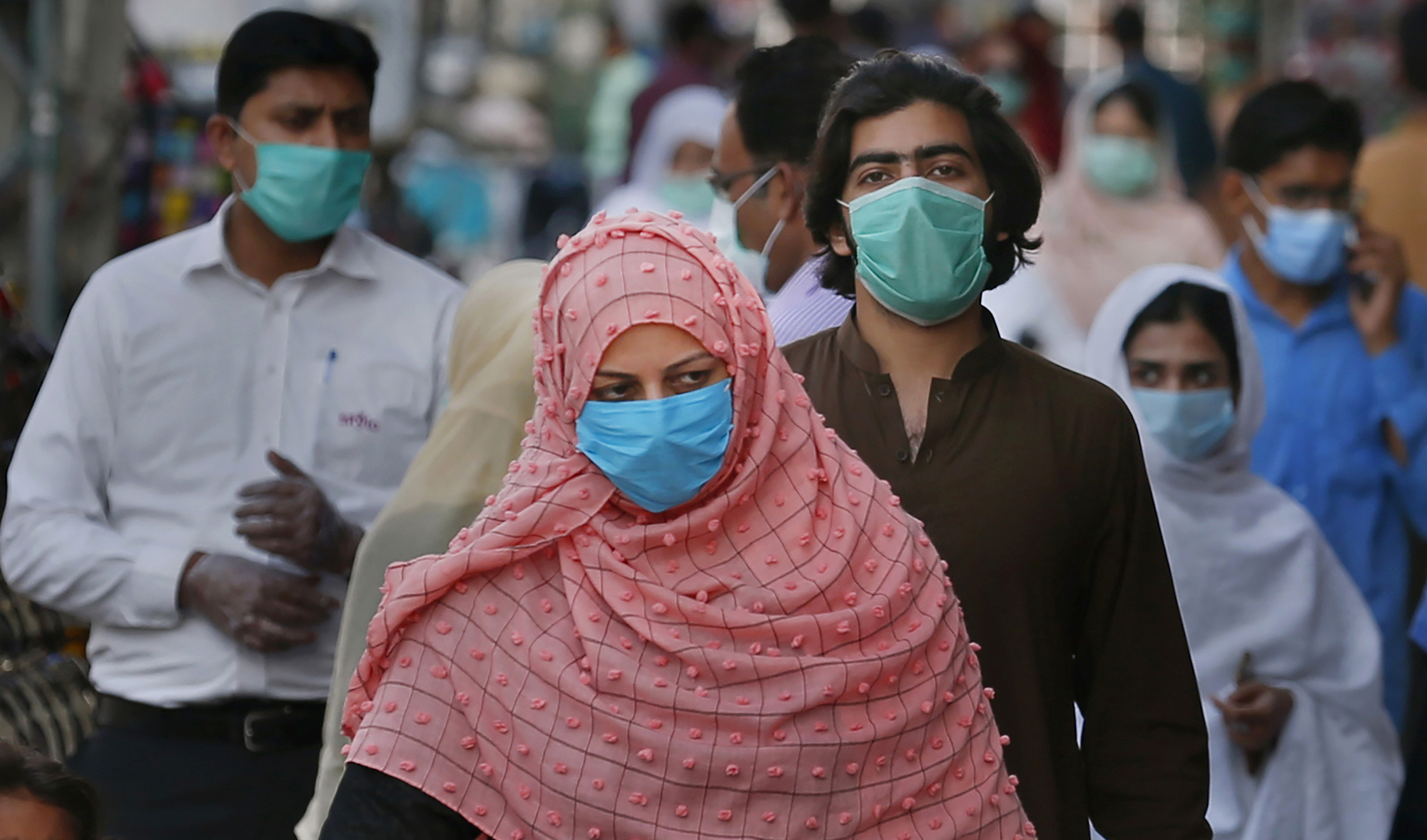 People wearing masks to help curb the spread of the coronavirus shop in a market in Rawalpindi on Jan. 2, 2020. (AP)