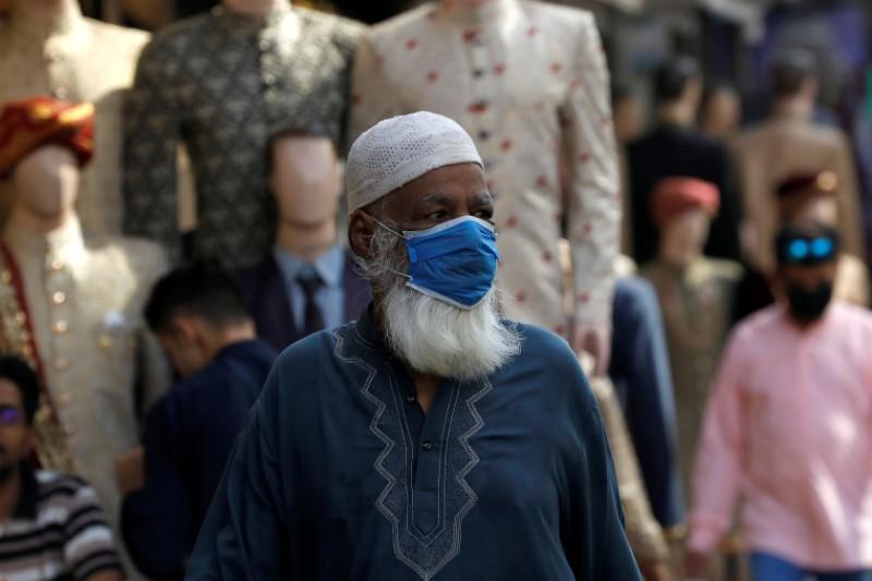 A man wearing a protective face mask, walks past shops at a market, as the outbreak of the coronavirus disease (COVID-19) continues, in Karachi, Pakistan June 1, 2020. (Reuters)