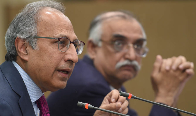 Adviser to the Prime Minister on Finance and Revenue Dr Abdul Hafeez Shaikh (L) and Chairman Federal Board of Revenue (FBR) Syed Shabbar Zaidi (R) address a media briefing in Islamabad on October 12, 2019. (AFP)