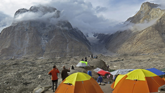 In this file photo, foreign tourists and porters rest at a camping site above Baltoro glacier in the Karakoram range of Pakistan's mountain northern Gilgit region on Aug. 12, 2019. (AFP)