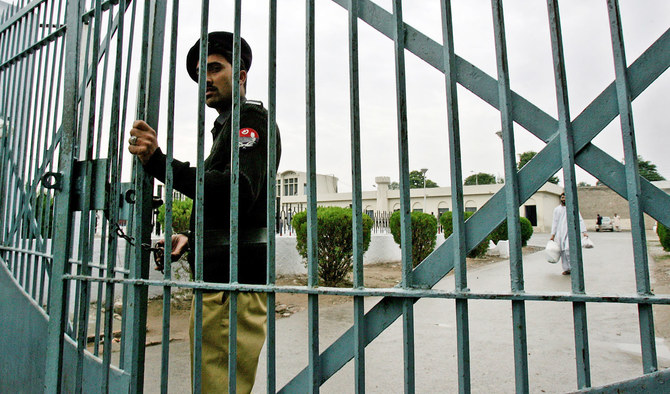 In this file photo, a Pakistani policeman closes the main gate of the Adiala Jail in Rawalpindi on Nov. 17, 2006. (AFP)