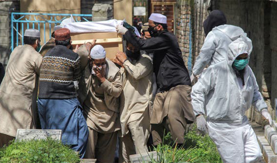 People move a coffin of a man who died due to coronavirus disease (COVID-19), for a burial at graveyard in Abbottabad, Pakistan. (File photo: Reuters)