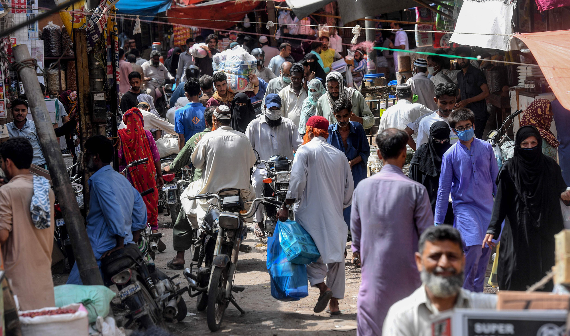 Residents shop at a wholesale market despite the spread of the COVID-19 coronavirus in Karachi on June 10, 2020. (AFP)