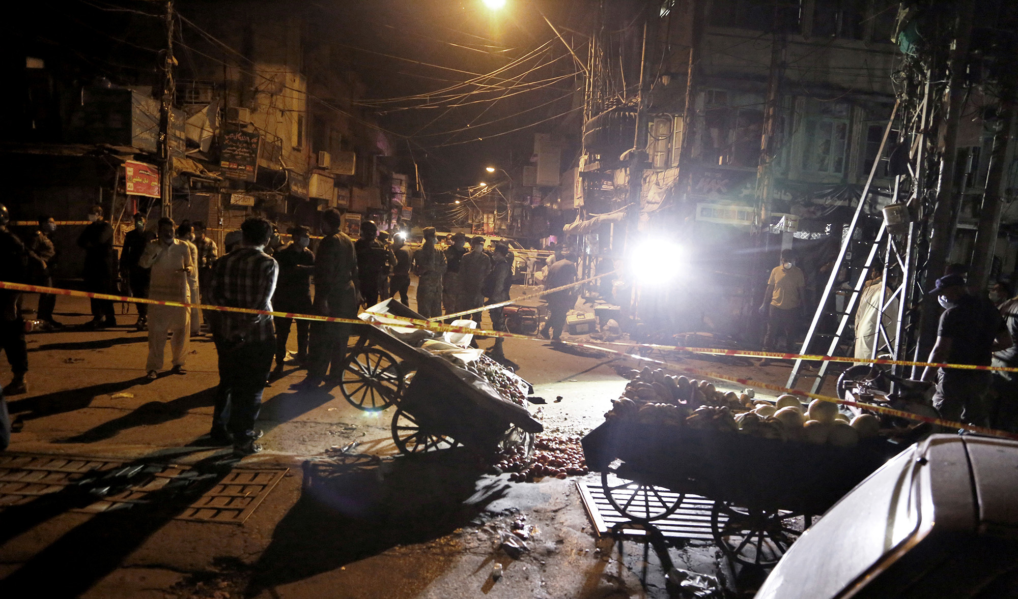 Pakistan's security officials examine the site of a bomb explosion that ripped through a bazaar in Rawalpindi on June 12, 2020. (AP)