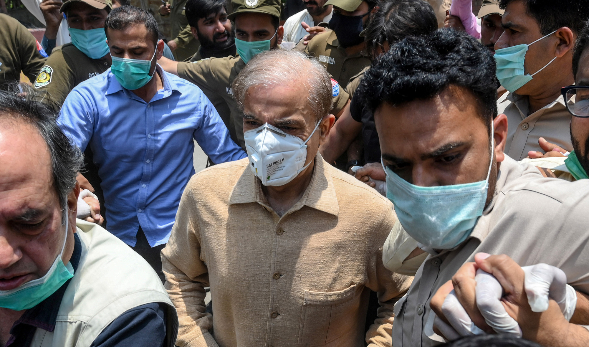 Pakistan's opposition leader Shahbaz Sharif, center, arrives at the High Court in Lahore on June 3, 2020. (AFP)