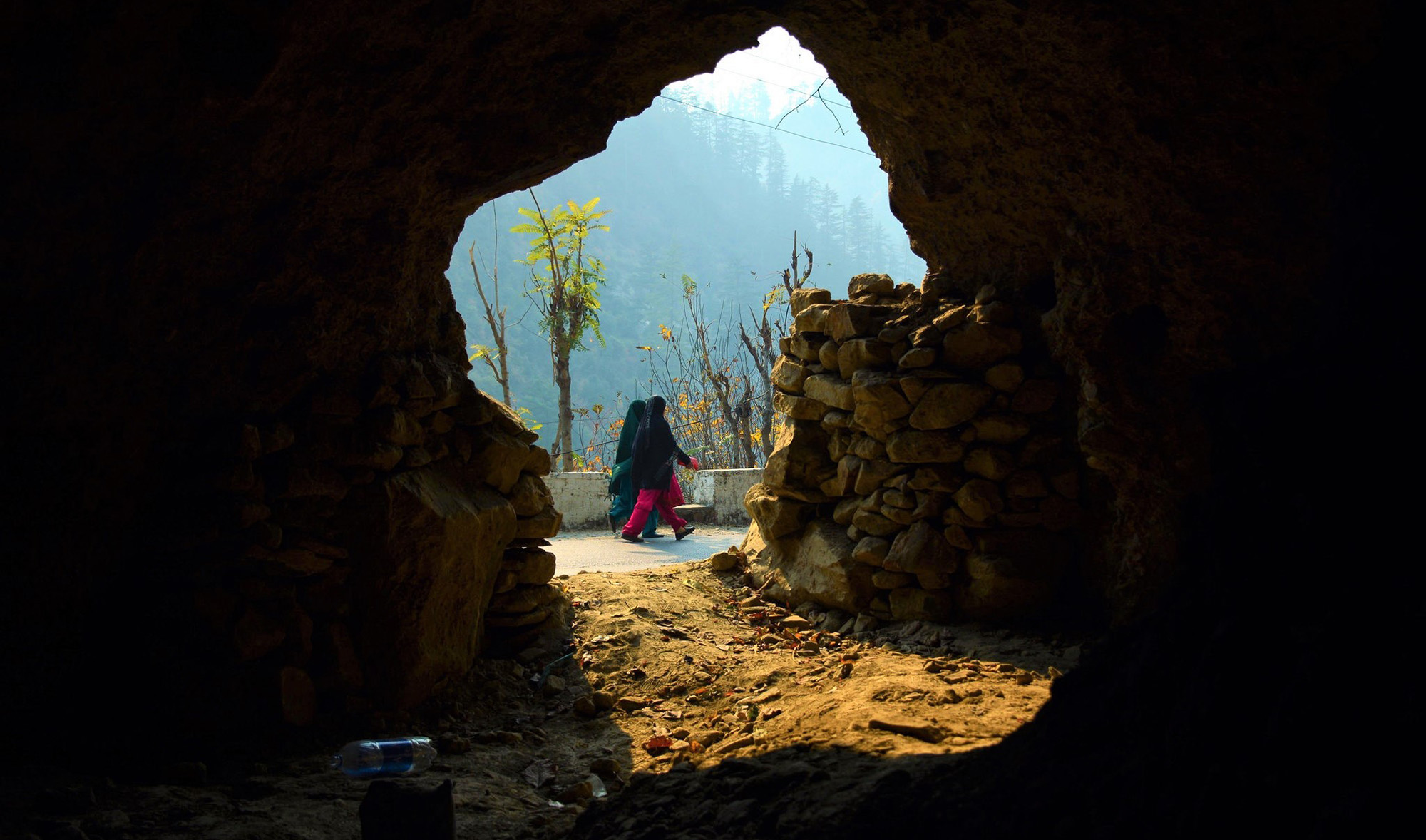 In this file photo, Pakistani Kashmiri women walk past a bunker in Athmuqam village at the Line of Control, the de facto border between Pakistan and India, in the Neelum Valley of Azad Kashmir on Nov. 18, 2016. (AFP)