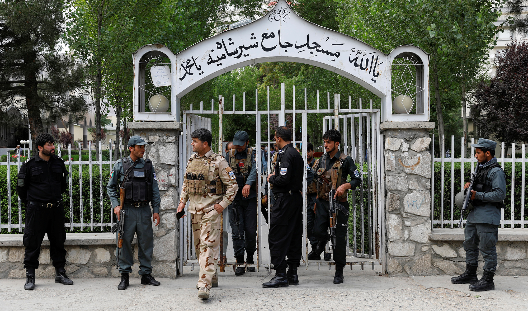 Afghan policemen inspect at the gate of a mosque after a blast in Kabul on June 12, 2020. (REUTERS)