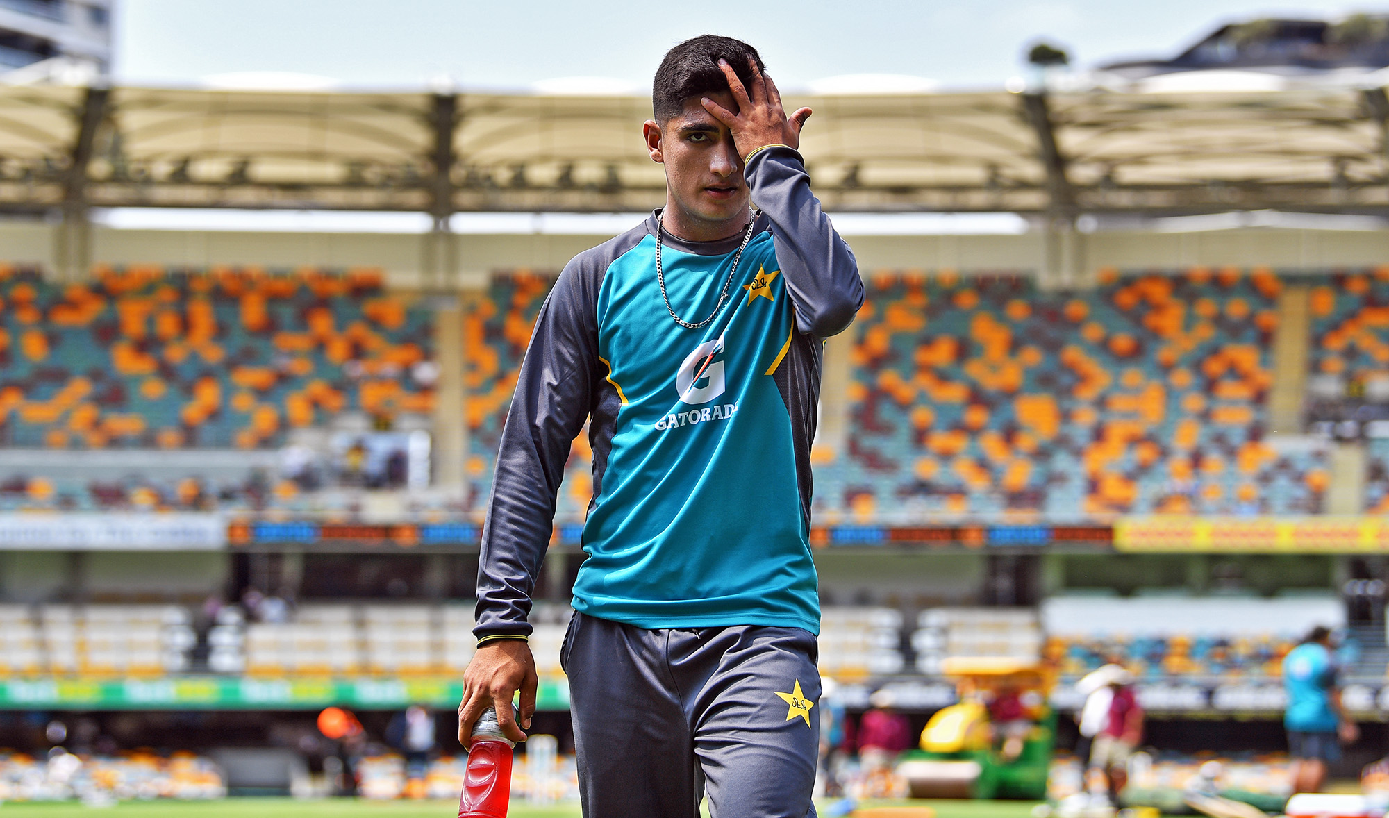In this file photo, Pakistan’s paceman Naseem Shah walks back to the pavilion after a light exercise prior to day two of the first Test cricket match between Pakistan and Australia at the Gabba in Brisbane on Nov. 22, 2019. (AFP)