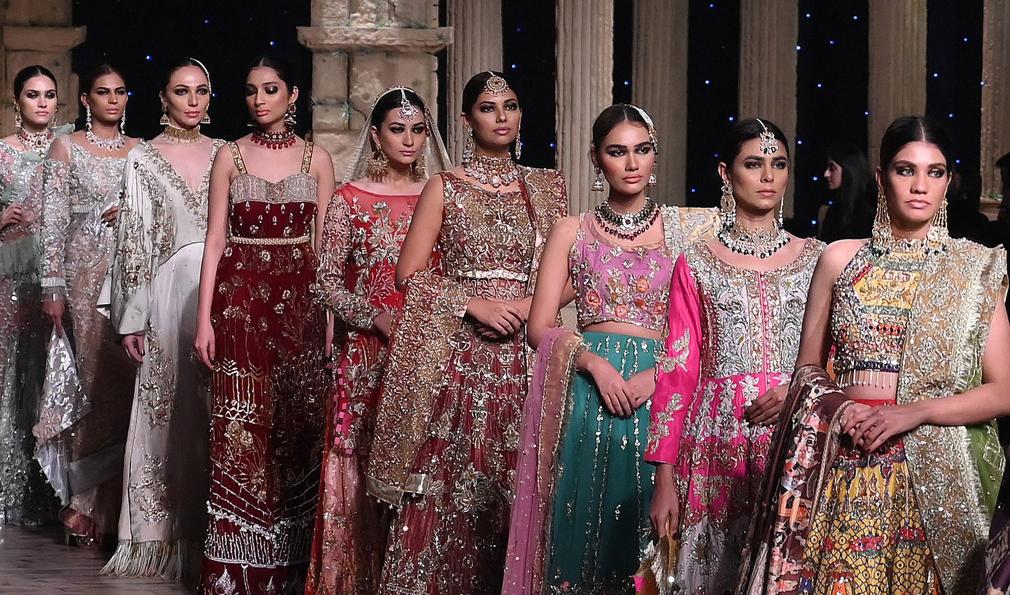 In this file photo, models parade at the end of “Madhubala” collection by Reema Ahsan during the Pantene Hum Bridal Couture Week in Lahore on Dec. 8, 2019. (AFP)