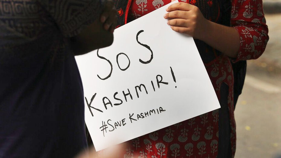 A student holds a banner before a protest against the government revoking Kashmir's special constitutional status in New Delhi, India, Monday, August 5, 2019. (AP / File photo)