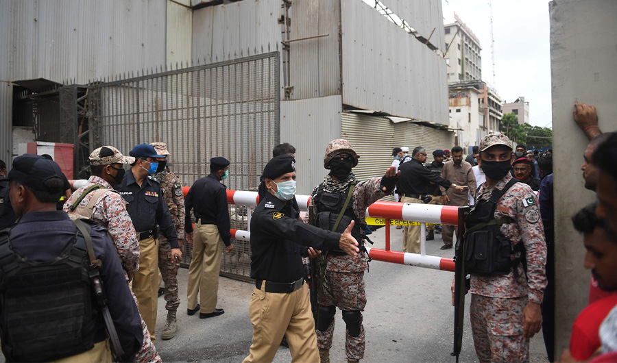 Security personnel gather at the main entrance of the Pakistan Stock Exchange building in Karachi on June 29, 2020. Gunmen attacked the Pakistan Stock Exchange in Karachi on June 29, with four of the assailants killed, police said. (AFP)