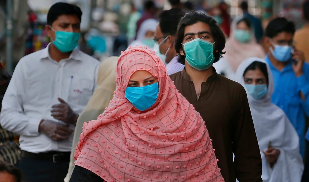 People wearing masks to help curb the spread of the coronavirus shop in a market in Rawalpindi on Jan. 2, 2020. (AP)