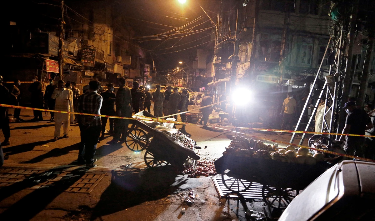 Pakistan's security officials examine the site of a bomb explosion that ripped through a bazaar in Rawalpindi on June 12, 2020. (AP)