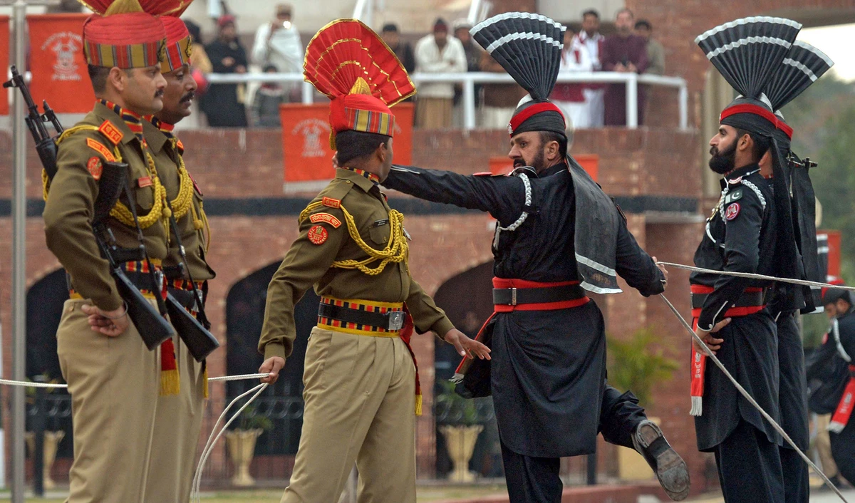 In this file photo, Indian Border Security Force personnel wearing brown uniforms and Pakistani Rangers wearing black uniforms take part in the Beating Retreat ceremony at the India-Pakistan Wagah border post on Jan. 22, 2019. (AFP)
