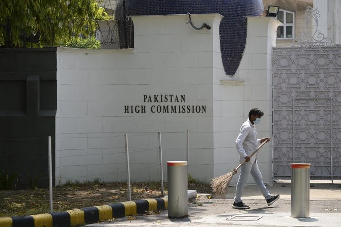 A man sweeps in front of the main gate of the Pakistan High Commission in New Delhi on June 1, 2020. (AFP)