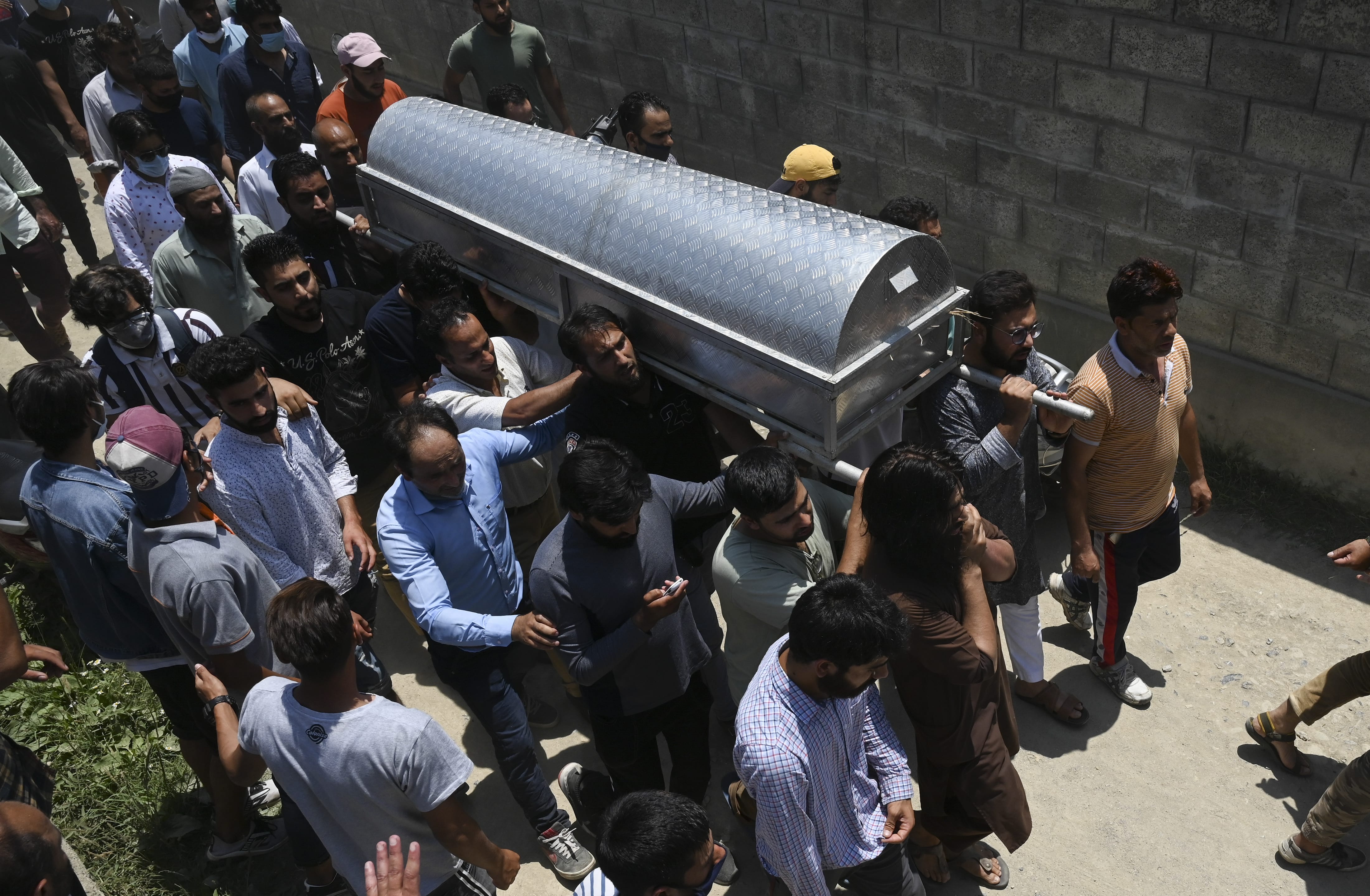Relatives and neighbours offer funeral prayers for Bashir Ahmed, a civilian who died during a gun-battle between government forces and suspected militants, in Srinagar on July 1, 2020. (AFP)