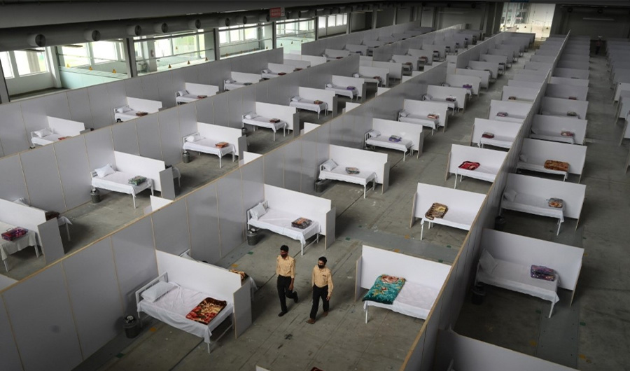 Private security guards walk along a temporary isolation facility set up at the Expo Center in Lahore on March 26, 2020. (AFP)