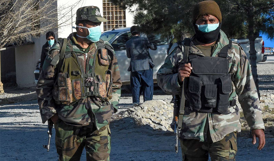 Soldiers wearing facemasks patrol at a quarantine camp prepared for people returning from Iran via the Pakistan-Iran border town of Taftan to prevent the spread of the COVID-19 coronavirus, on the outskirts of Quetta on March 13, 2020. (AFP)