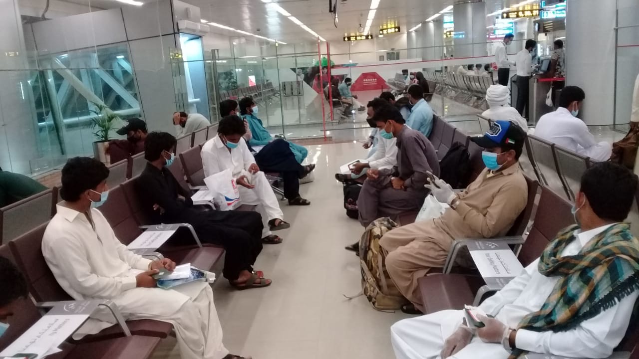 A group of Pakistanis who were stranded in the UAE by the coronavirus outbreak are waiting at Sharjah International Airport to board a flight to Karachi on July 15, 2020. (Photo courtesy: Taimoor H.)