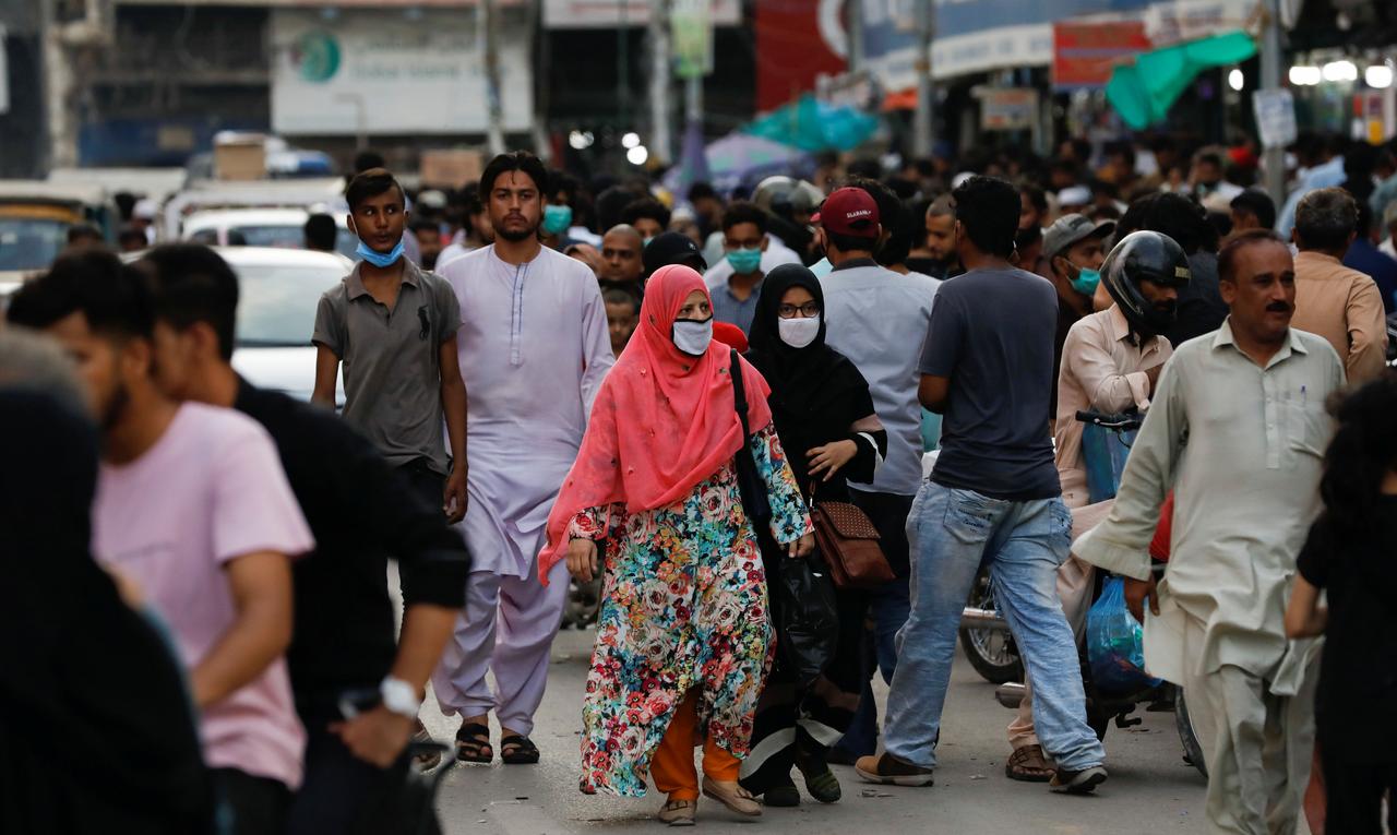 Women wearing protective face masks walk amid the rush of people along a road as the outbreak of the coronavirus disease (COVID-19) continues, in Karachi, Pakistan July 20, 2020. (Reuters)