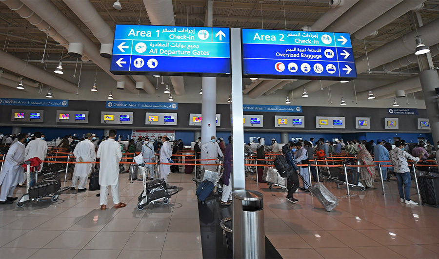 Pakistani nationals check in at the Dubai International Airport before leaving the Gulf Emirate on a flight back to their country, on May 7, 2020, amid the novel coronavirus pandemic crisis. ( AFP Photo)