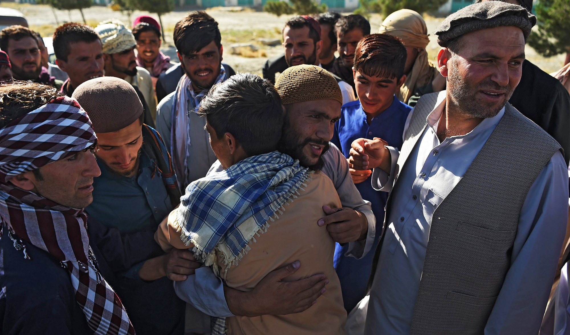 A Taliban prisoner, center, greet relatives after his release from the Bagram prison, outside of the US military base in Bagram, some 50 km north of Kabul. Afghan authorities plan to release 900 more Taliban prisoners on May 26, as calls grow for the militants to extend a ceasefire on its third and final day.