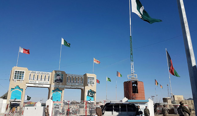 In this photograph taken on January 7, 2017, Pakistan security personnel look on as travelers wait to cross the border between Pakistan and Afghanistan at Chaman. (AFP)