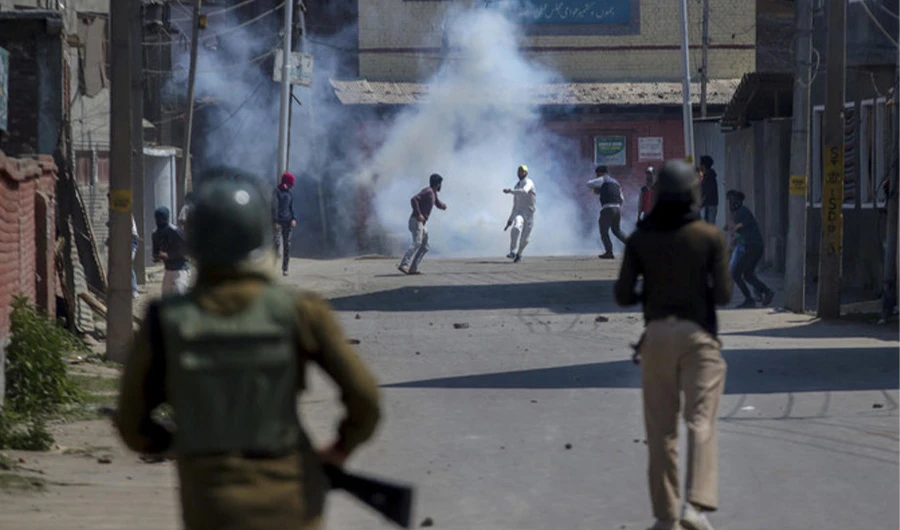 Kashmiri protesters engulfed in tear gas smoke clash with Indian paramilitary soldiers during a protest against the killing of rebels in Srinagar, Indian controlled Kashmir, Sunday, April 1, 2018. (AP)