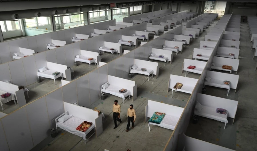 Private security guards walk along a temporary isolation facility set up at the Expo Center in Lahore on March 26, 2020. (AFP)