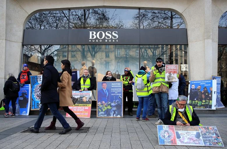 People walk by a Hugo Boss store in Paris, France February 9, 2019. (REUTERS)