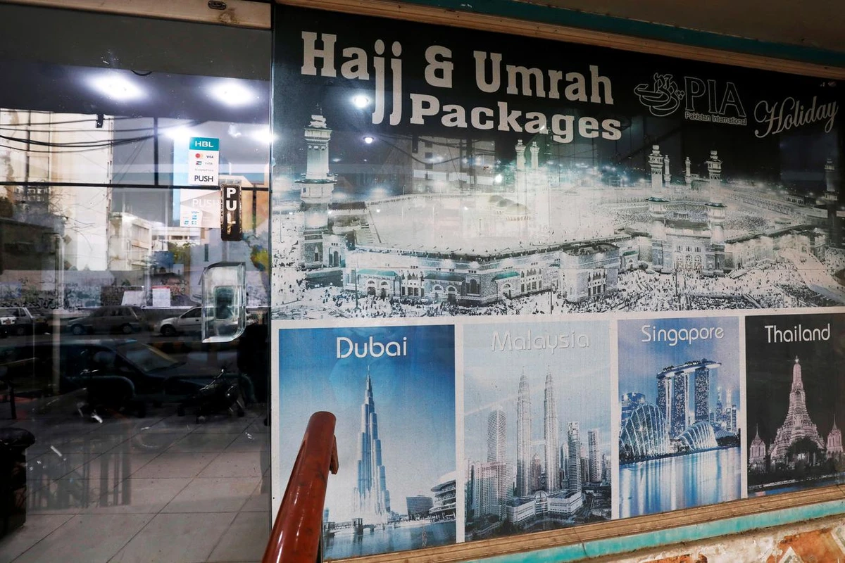 A sign promotes airline's Haj and Umrah packages outside a ticketing office, as the spread of the coronavirus disease (COVID-19) continues, in Karachi, Pakistan July 6, 2020. (REUTERS)
