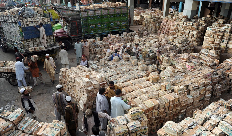 Pakistani vendors and labourers gather near crates containing mangoes at a fruit market in Karachi on August 7, 2012. ( AFP/File)