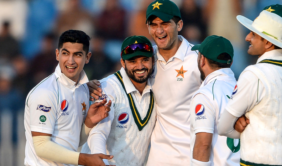 This file photo taken on February 7, 2020 shows Pakistan's Azhar Ali (2nd L) celebrating with teammates Naseem Shah (L) and Shaheen Shah Afridi (3rd L) after the dismissal of Bangladesh's Mohammad Mithun (unseen) during the first day of the first cricket Test match between Pakistan and Bangladesh at the Rawalpindi Cricket Stadium in Rawalpindi. (AFP)