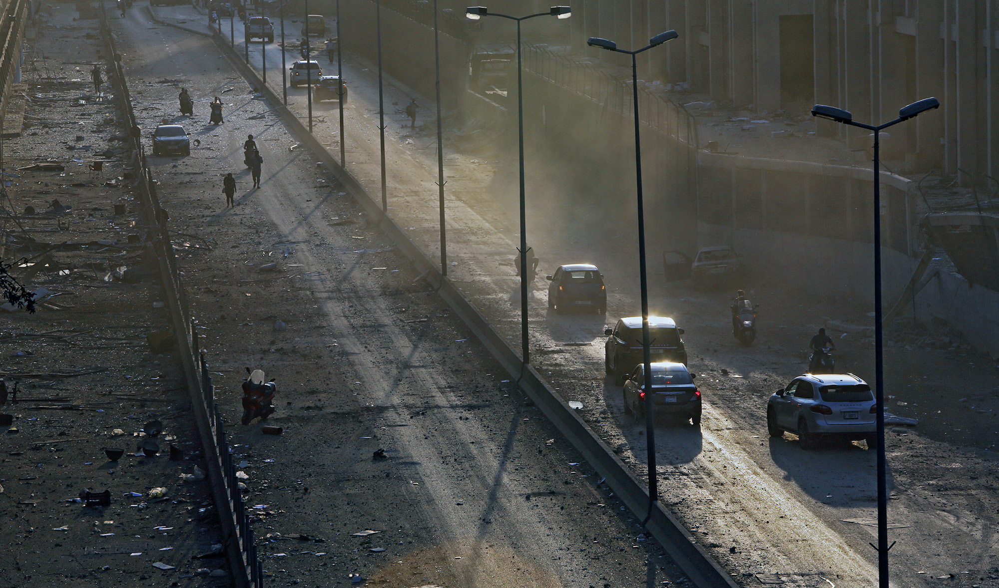 Debris is seen on a main road in Beirut at sunset following a twin explosion that shook the port of Lebanon's capital on Aug. 4, 2020. (AFP)