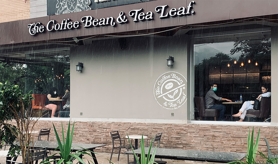 People enjoying their coffee in a rainy day in Islamabad on August 10, 2020 after government's decision to open restaurants across Pakistan as the coronavirus cases are declining in the country. (AN Photo)