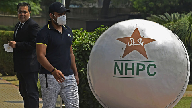 Pakistan's cricketer Umar Akmal (2nd L) arrives with his lawyer at the Pakistan Cricket Board office, in Lahore on July 29, 2020. (AFP)