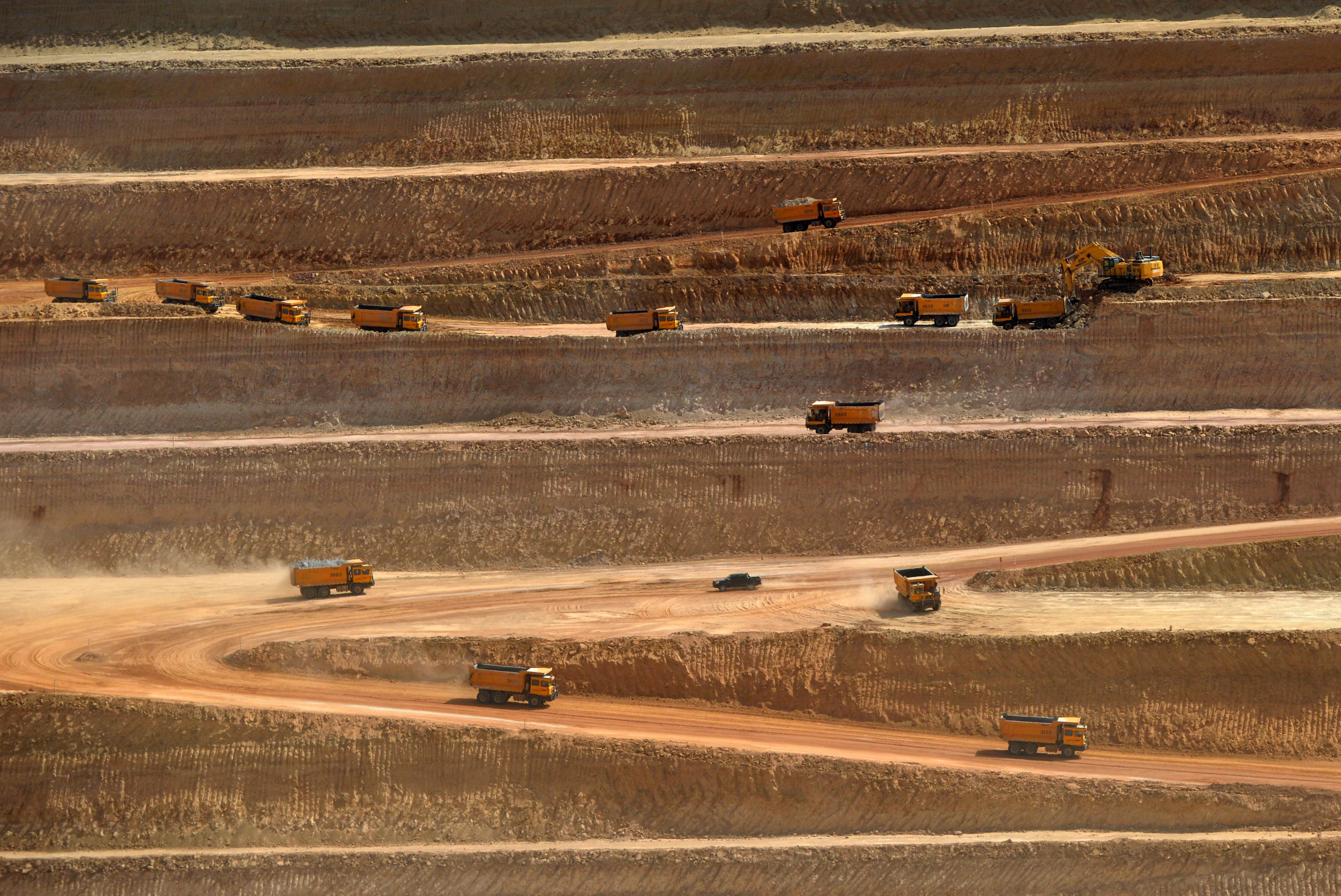 This picture taken on May 23, 2018 shows trucks transporting soil in an open-pit coal mining site at Islamkot in the desert in the Tharparkar district of Pakistan's southern Sindh province. (AFP/ File photo)