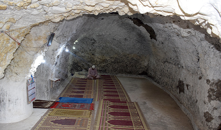 A man reads the Quran inside the Ghar-e-Sur mosque in the South Waziristan tribal district in Pakistan on August 13, 2020. (AN Photo)