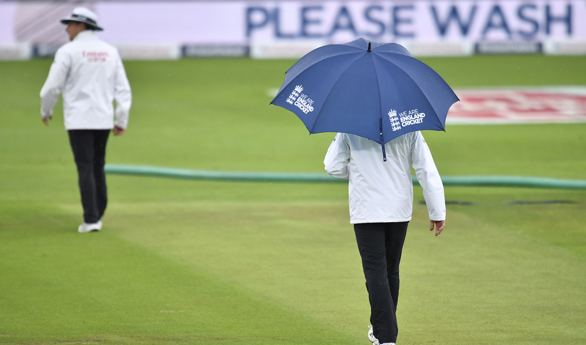 Umpire walk off the field after rain stopped play during the fourth day of the second cricket Test match between England and Pakistan, at the Ageas Bowl in Southampton, England on Aug. 16, 2020. (Pool via AP)