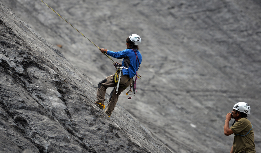 In this photograph taken on August 4, 2014, a Pakistani student from the Shimshal Mountaineering School climbs a slope on a glacier as trainer Niamat Karim (R) looks on near the Shimshal village in the northern Hunza valley. (AFP)