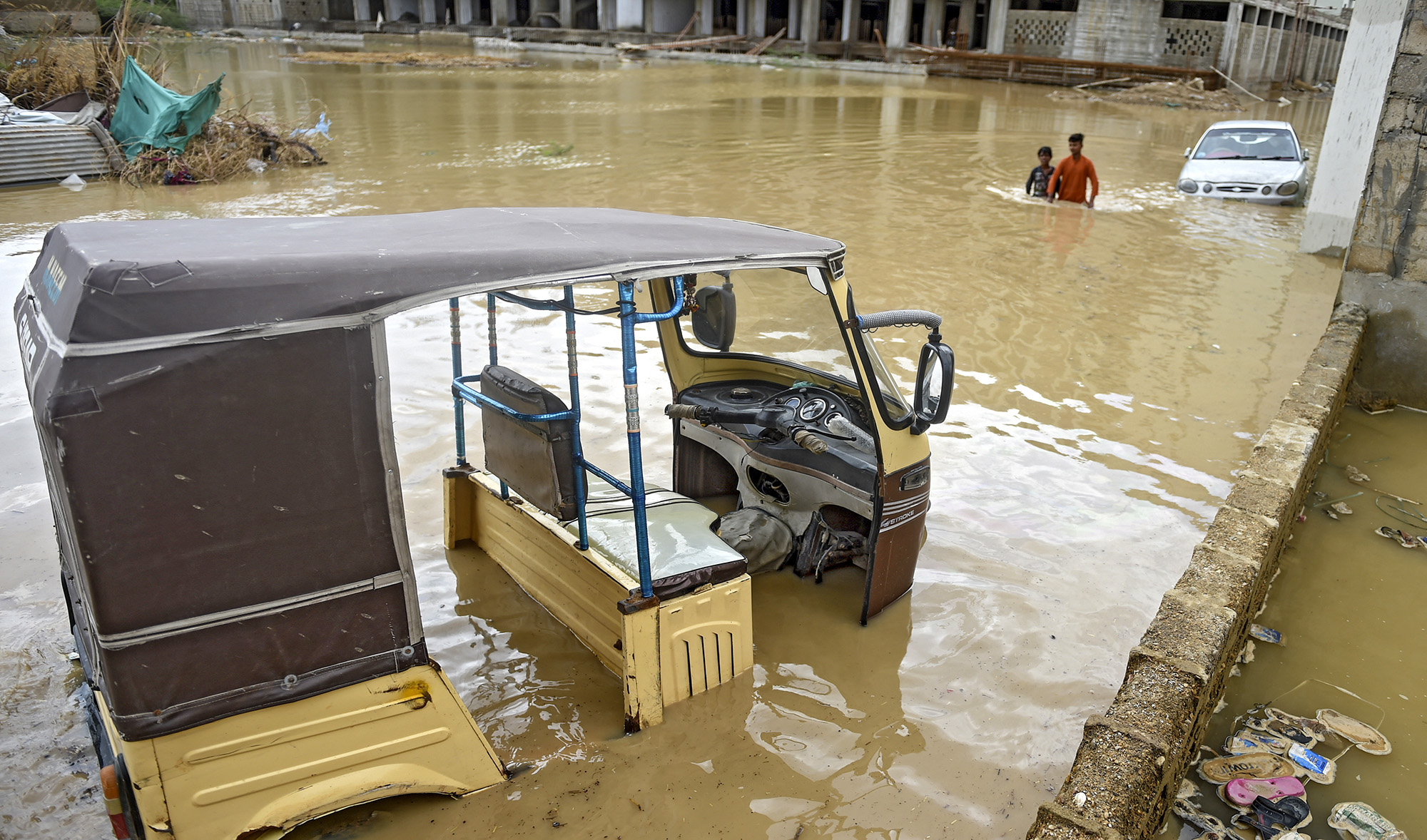 An auto-rickshaw is submerged by floodwaters during heavy monsoon rains in Karachi on July 31, 2019. (AFP/File)