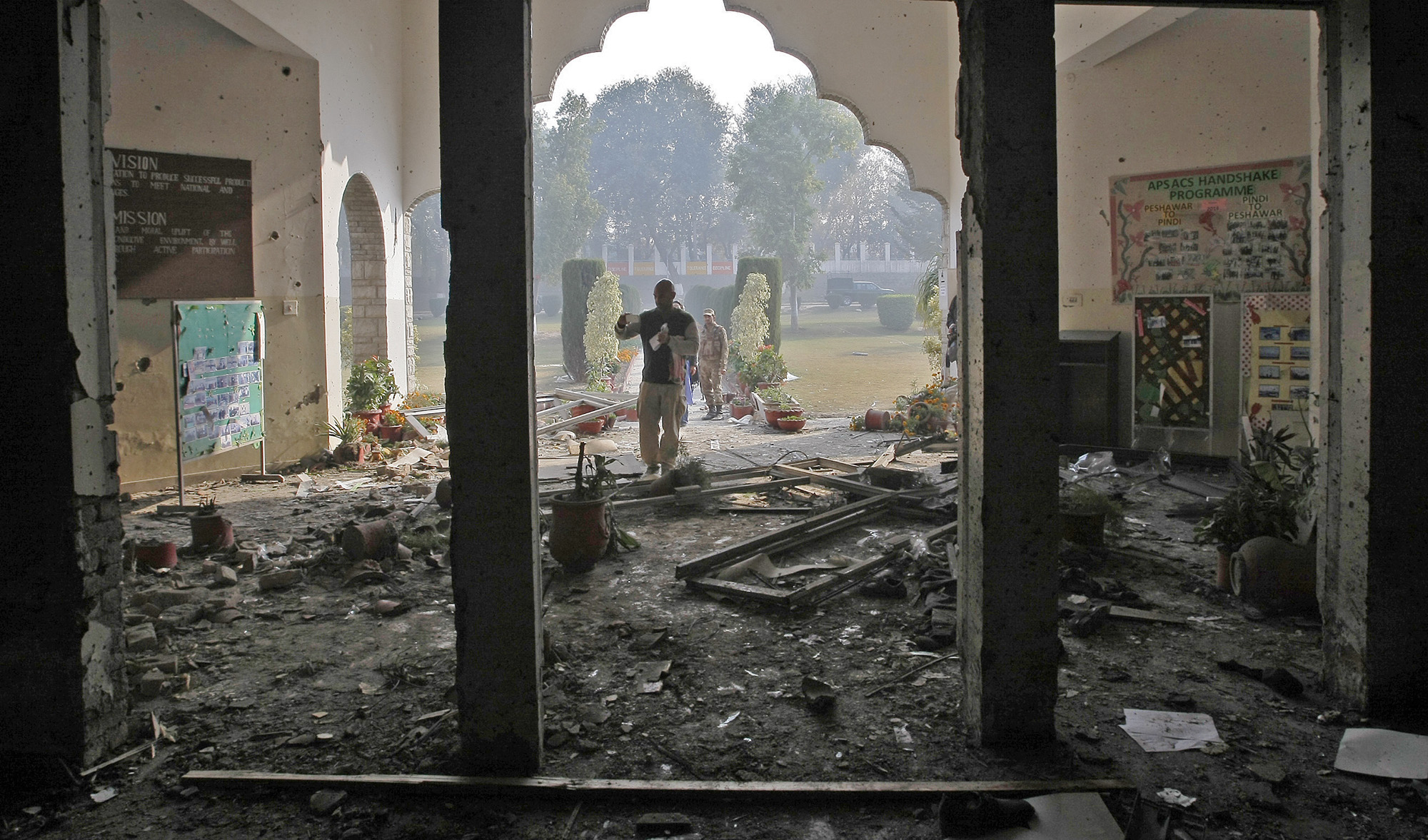 This photograph taken on Dec. 17, 2014 shows Pakistan Army soldiers inspecting the Army Public School in Peshawar that was attacked by Taliban gunmen a day before. (AP/File)