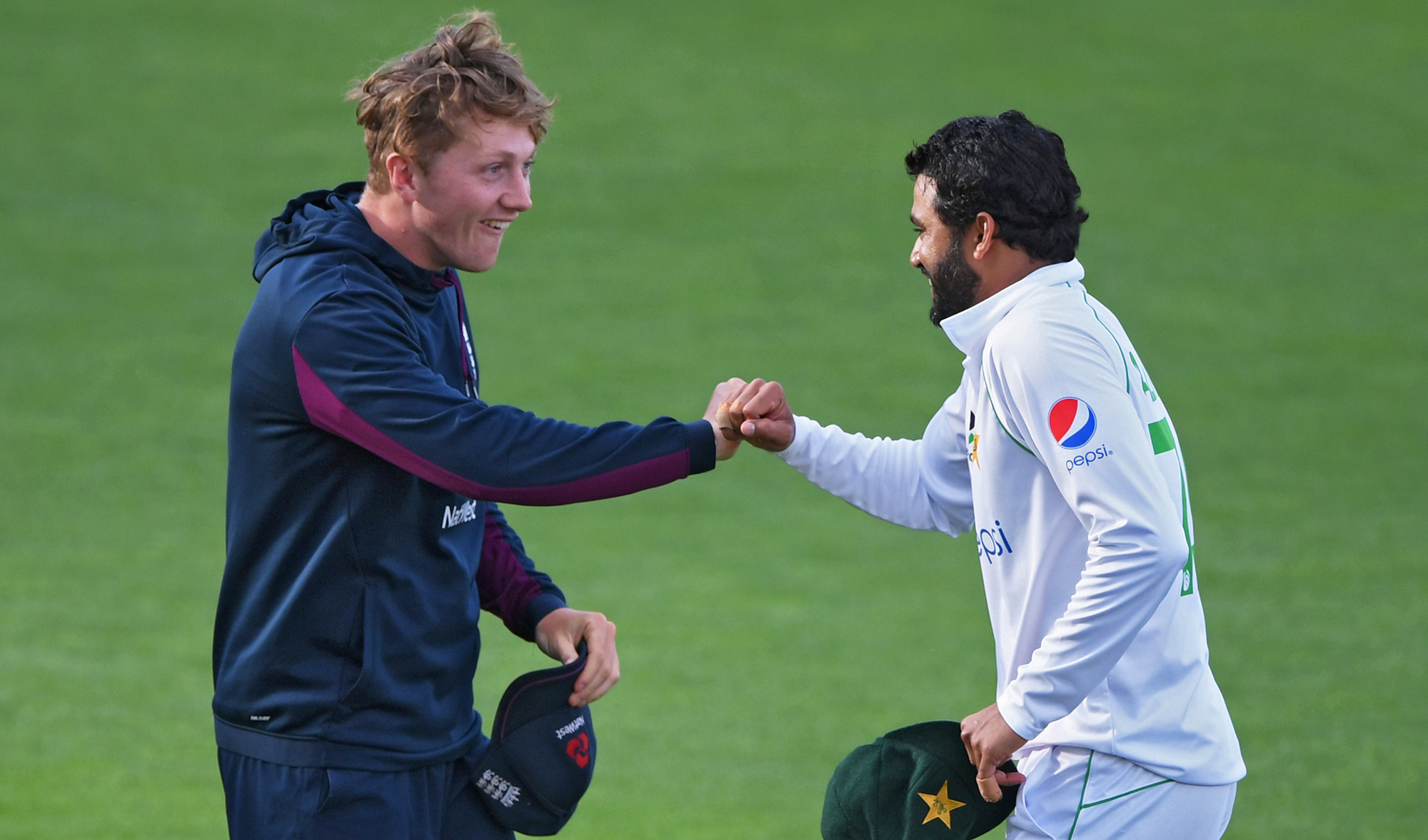 Pakistan's Azhar Ali, right, and England's Dom Bess fist pump after the second test match between England and Pakistan in Southampton was drawn on Aug. 17, 2020. (Pool via REUTERS)